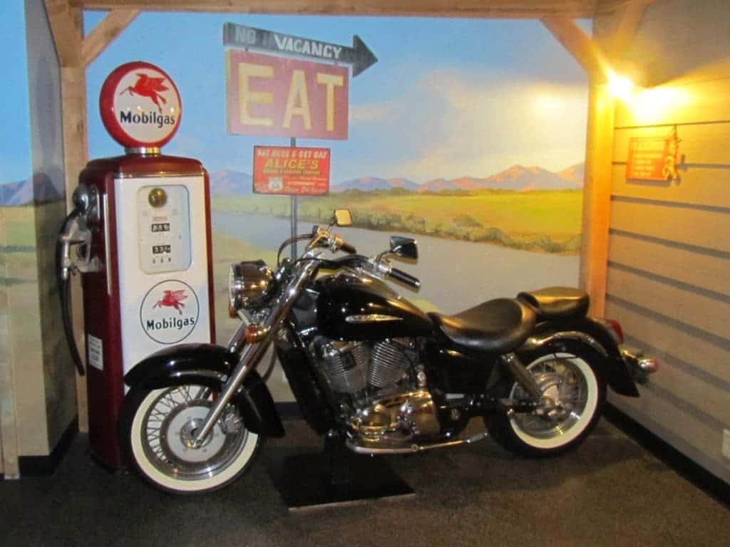 An antique Harley-davidson motorcycle sits beside an antique Mobilgas pump in one of the unique suites at the Anniversary Inn located in Logan, Utah. 