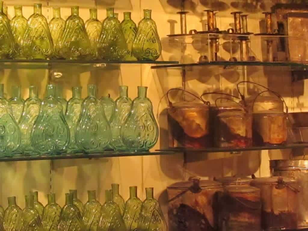 Glass shelves are loaded with collections of various items recovered from the steamboat.