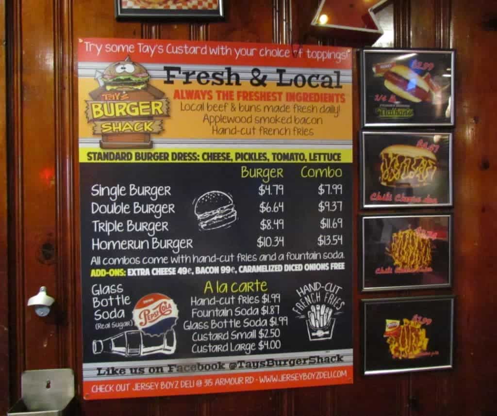 The brightly colored menu at Tay's Burger Shack lists the options available for thier grass fed beef burgers. Side dishes are minimal, but they also feature Nathan's hot dogs.