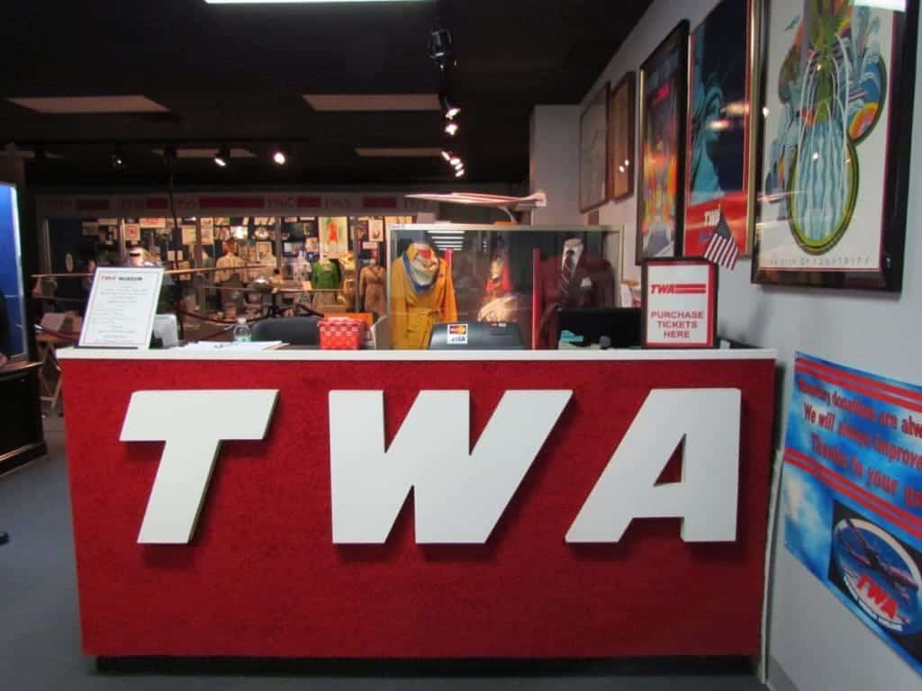 The TWA logo is prevalent on the desk front at the entrance to the TWA Museum.