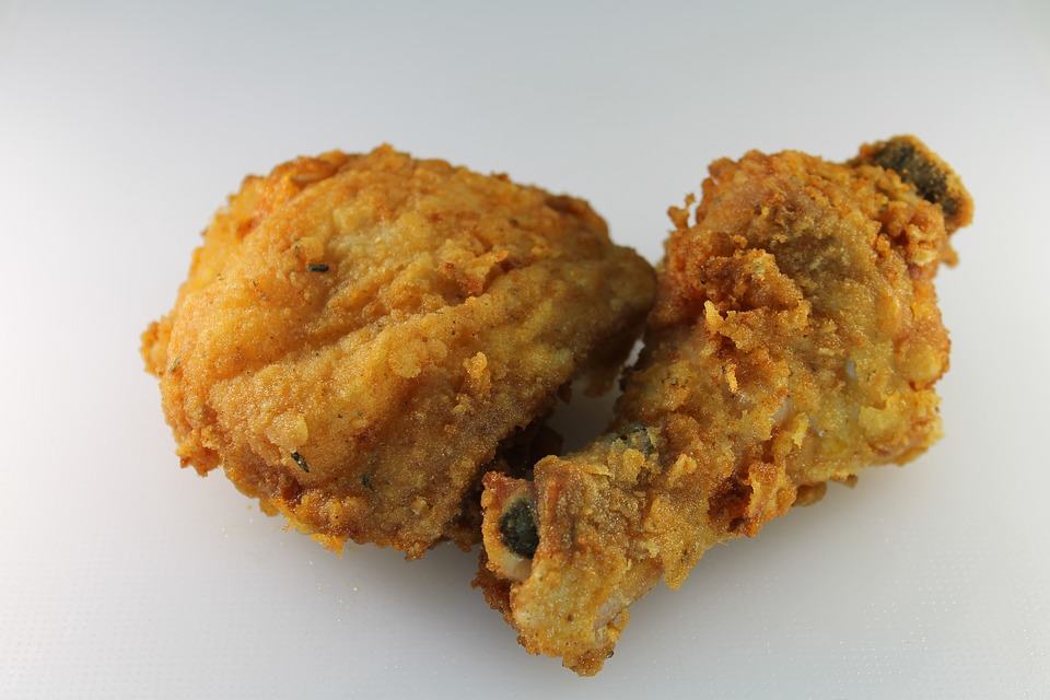A couple of pieces of fried chicken make the base of a delicious meal.