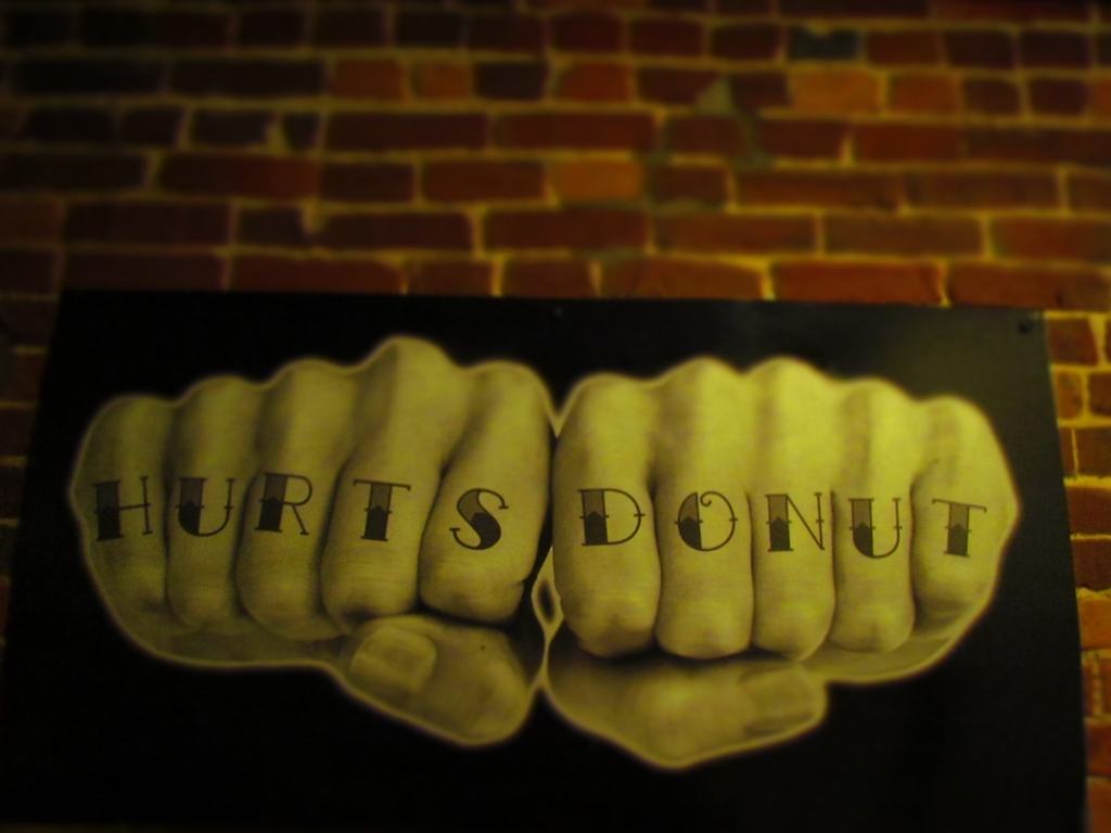 Hurts Donut sign with knuckles.