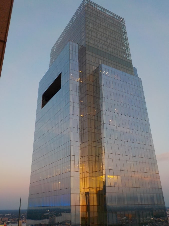 Sunset glows on a glass sided skyscraper.