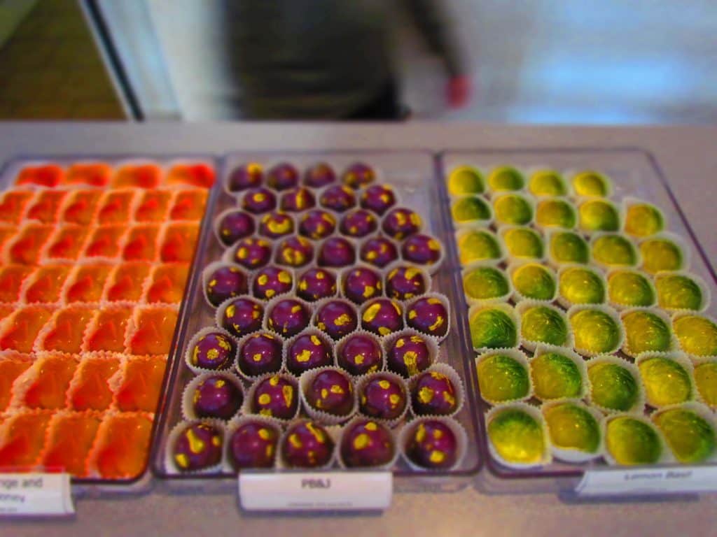 Trays filled with colorful artisan chocolates are found at Glacier Confection.