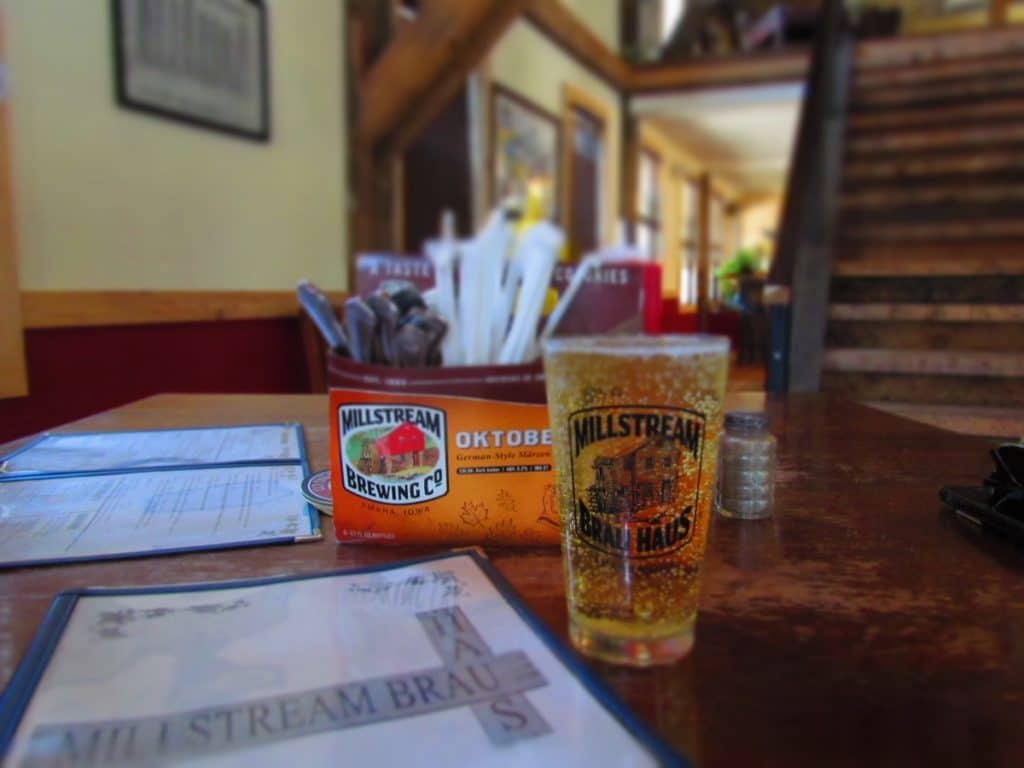 A cold craft glass of brew sits on the hand crafted tables in the dining room of Millstream Brau Haus.