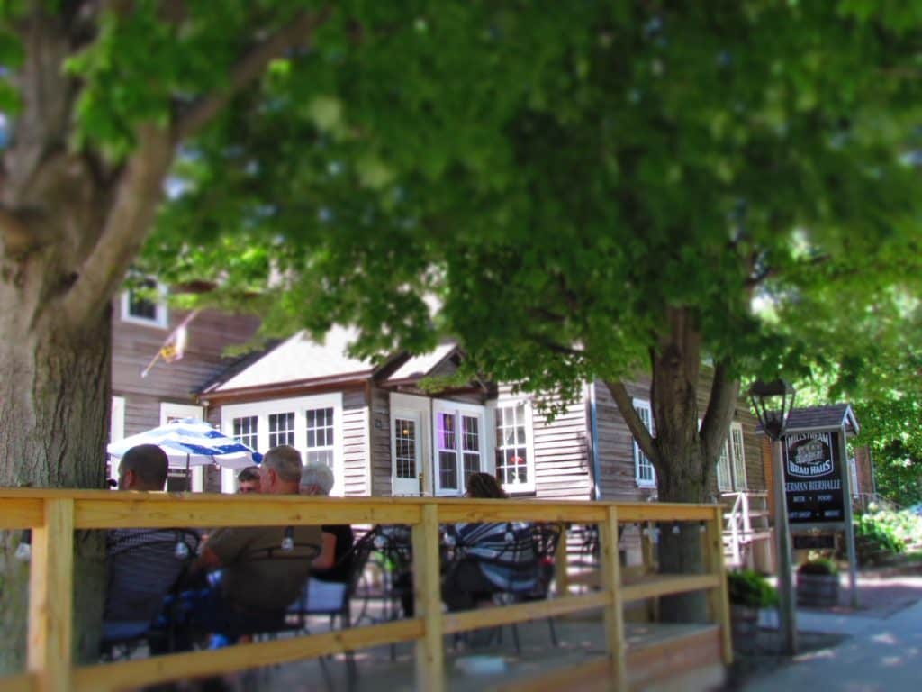 Diners sit casually in the shade on the outdoor patio at Millstream Brau Haus.