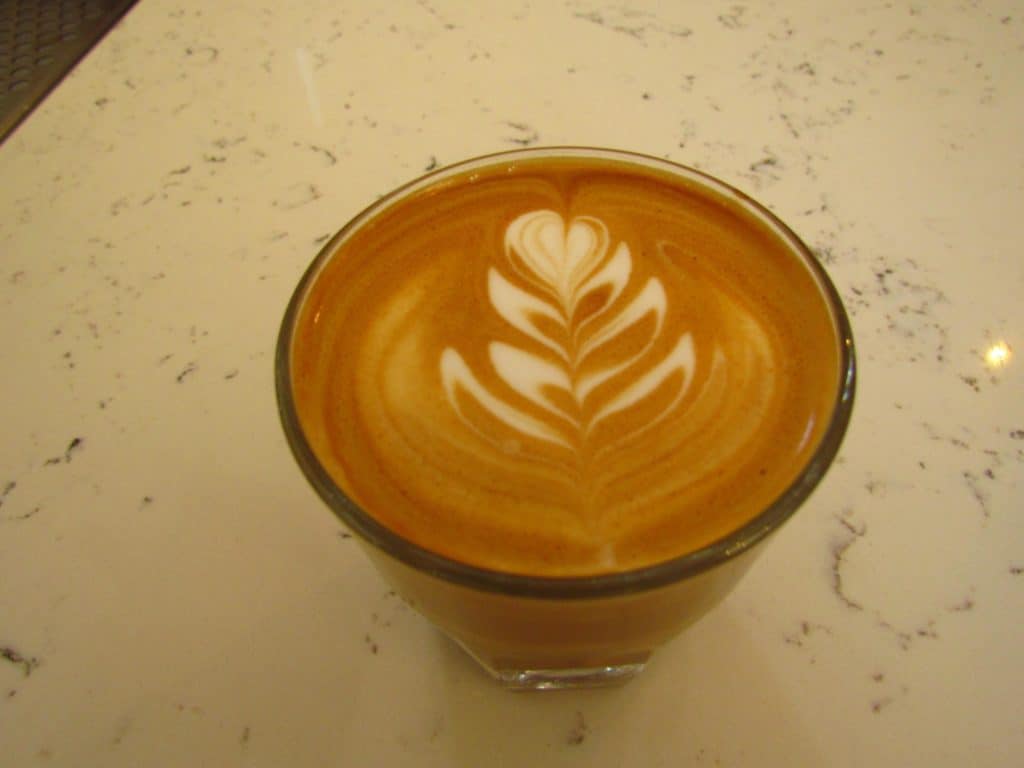 An artistic design adorns a coffee drink.
