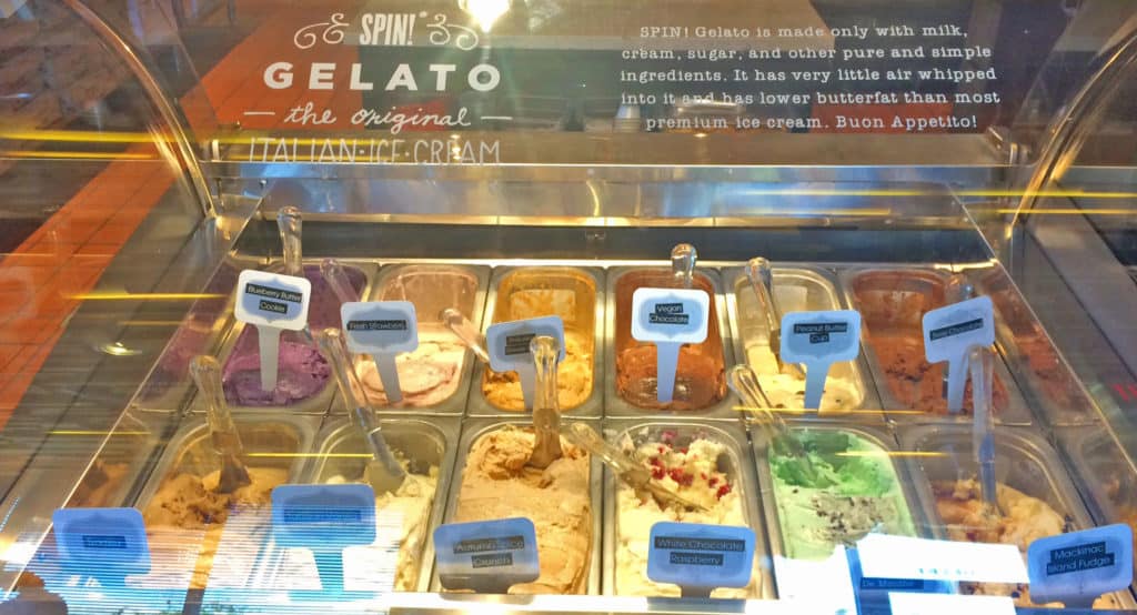 A display case filled with various flavors of gelato.