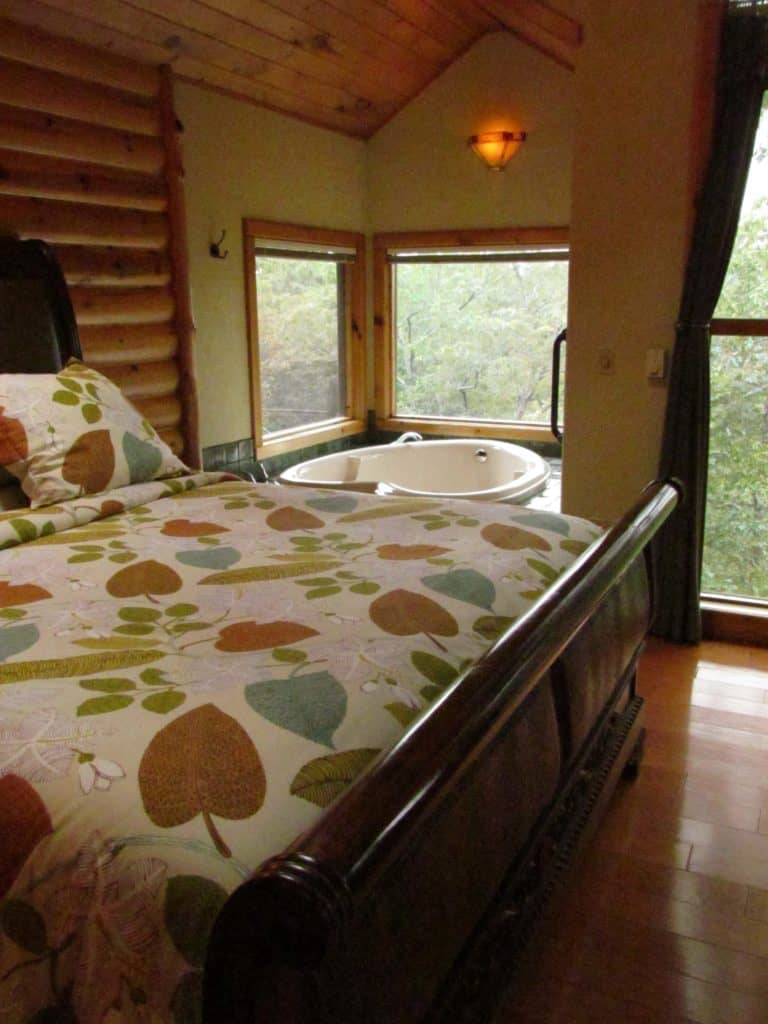 A heart shaped Jacuzzi tub offers a great spot to view the forest that surrounds the Treehouse Cottages.