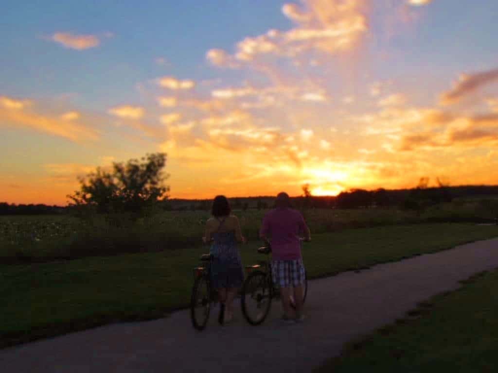 Authors taking in a beautiful Iowa sunset during a bike ride.