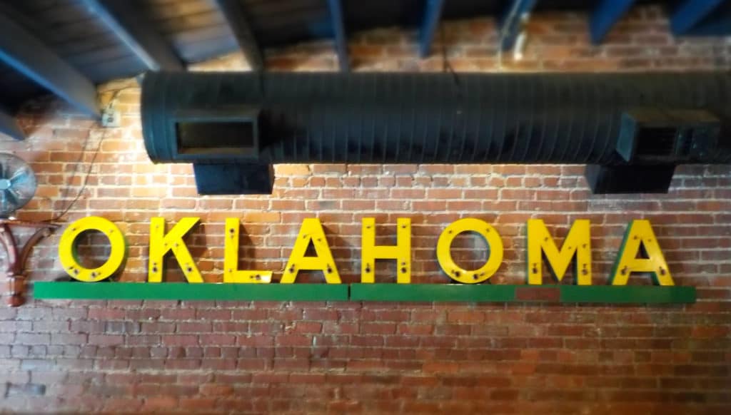 The brick walls are a great backdrop for the yellow metal letters that spell out Oklahoma.