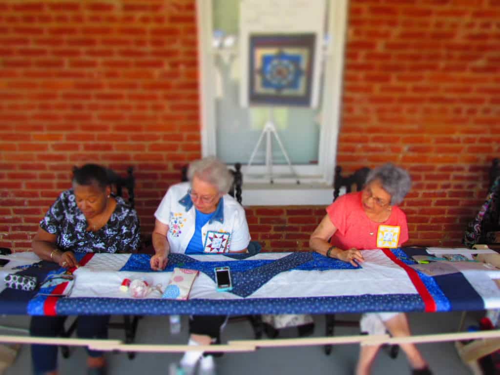 Members of the Grinter Quilting Bee work on a project.