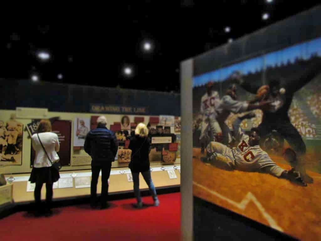 Visitors examine displays about the history of the Negro Leagues baseball Museum.