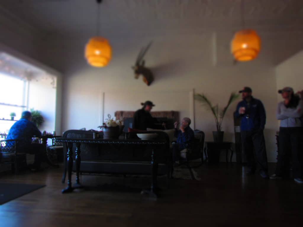 Customers relax around the modern fireplace in a seating area at Third Space Coffee.