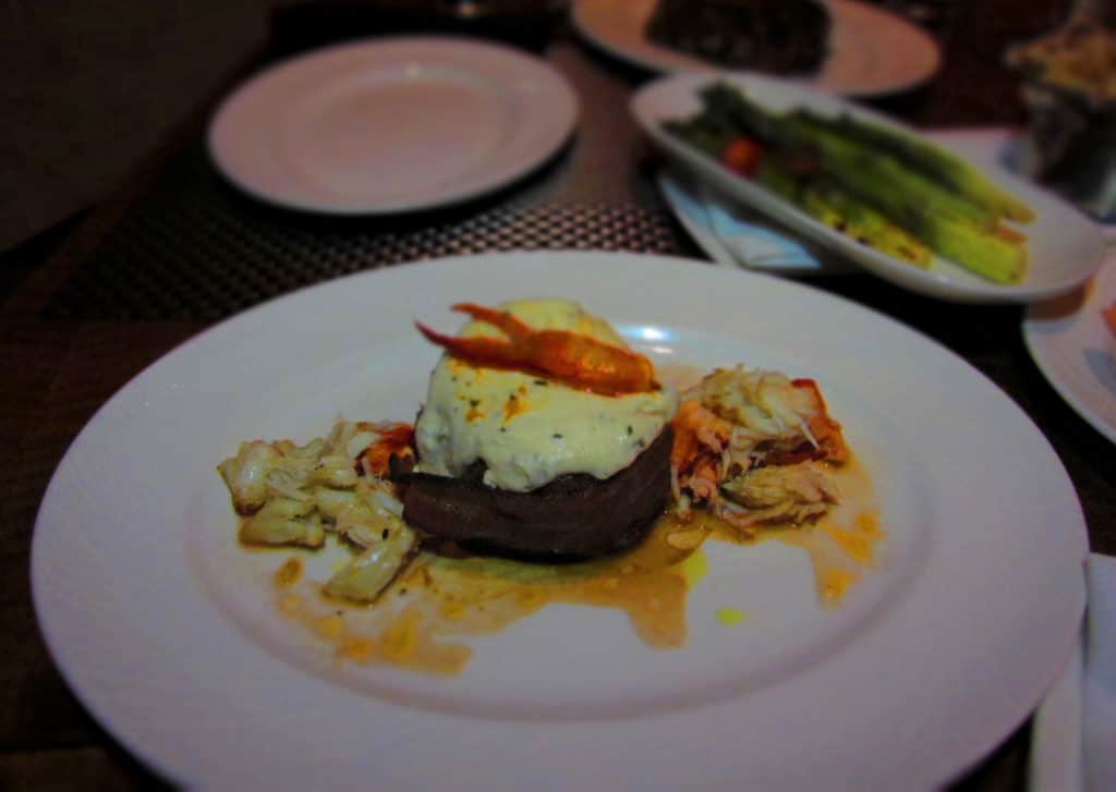 The Filet Mignon is wrapped with bacon and topped with cheese, crab, and lobster.