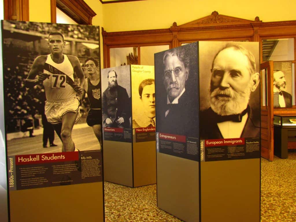 Over-sized standing placards reflect on the peopl and groups who helped shape the future of Lawrence, Kansas.