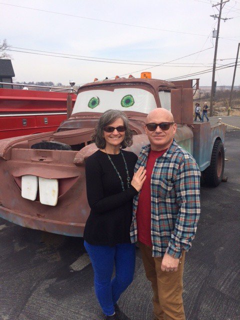 The authors pose in front of an inspiration from the movie Cars.