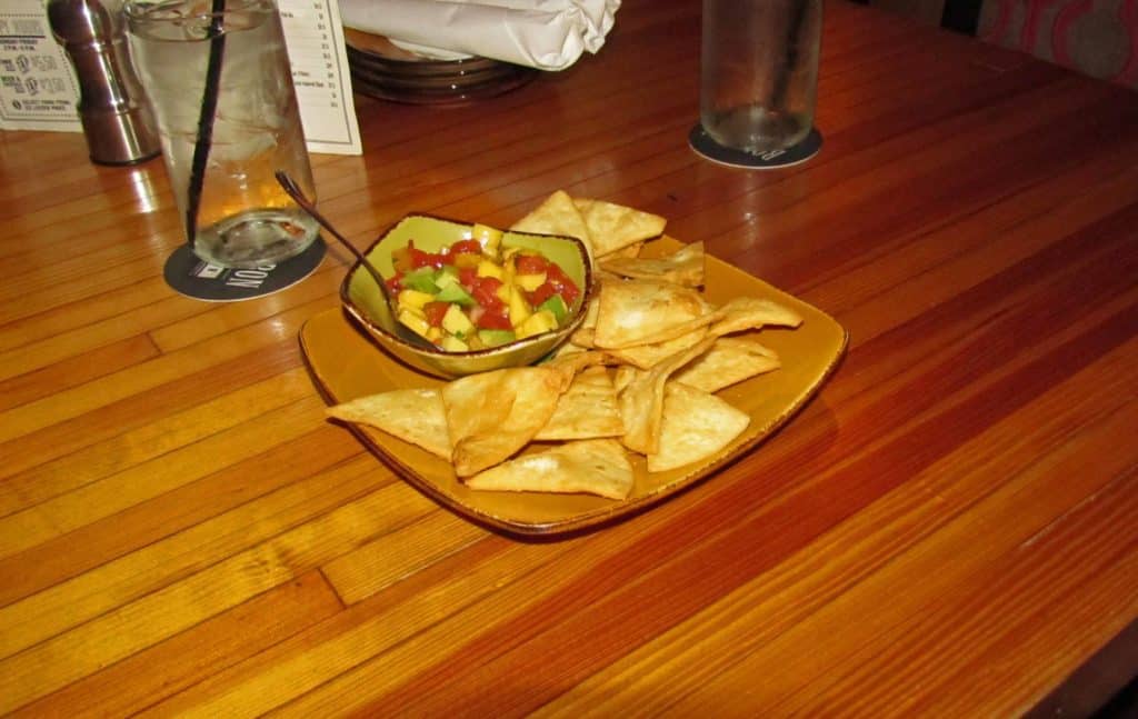 A sweet and tangy ceviche is paired with crispy tortilla chips.