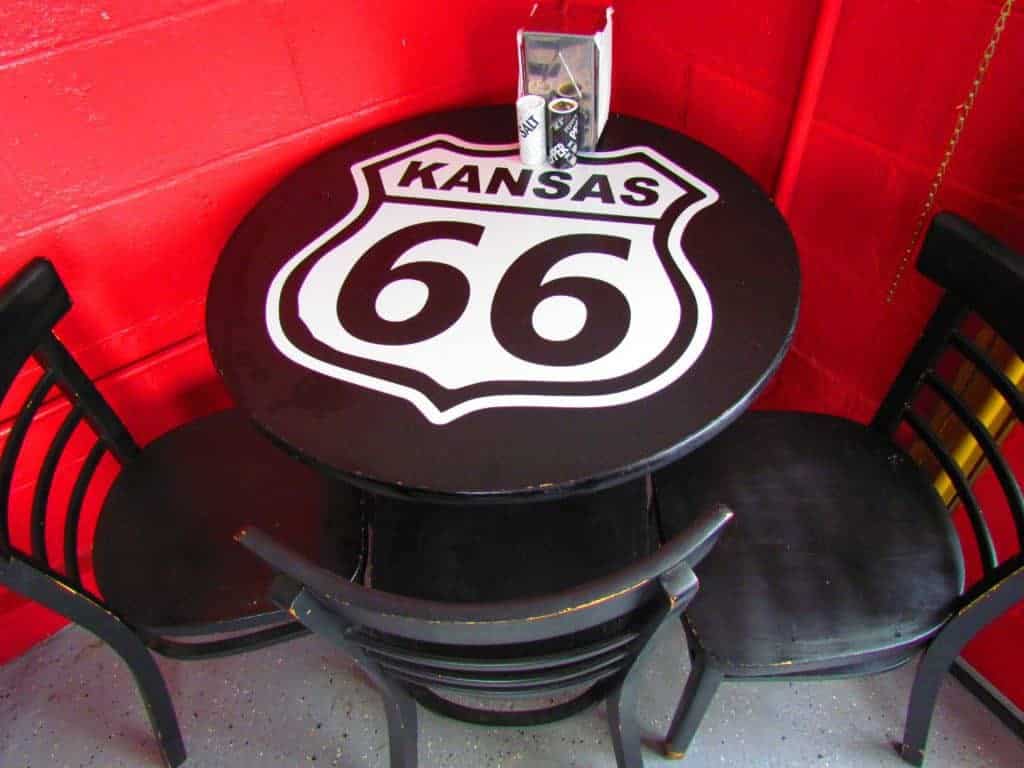 A tabletop is decorated with the familiar Route 66 highway shield.