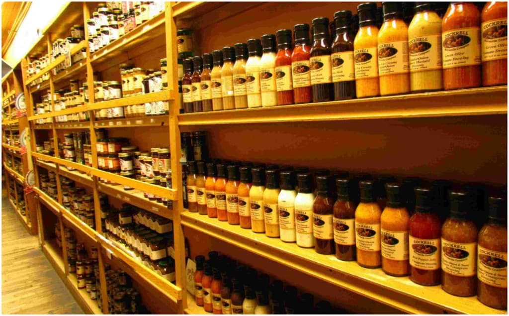 An aisle is filled from floor to ceiling with all types of sauces and mixes. 