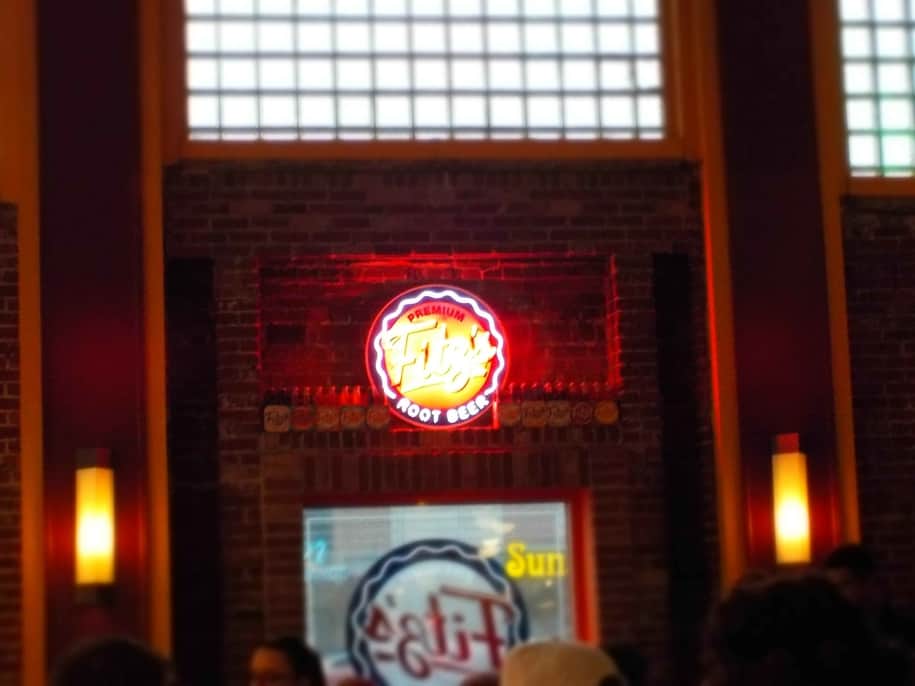 The Fitz's neon light shines brightly in the interior of the restaurant.