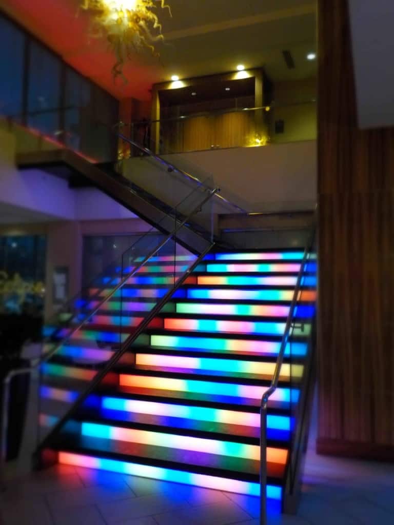 The lobby staircase features lights that change in an inviting pattern.