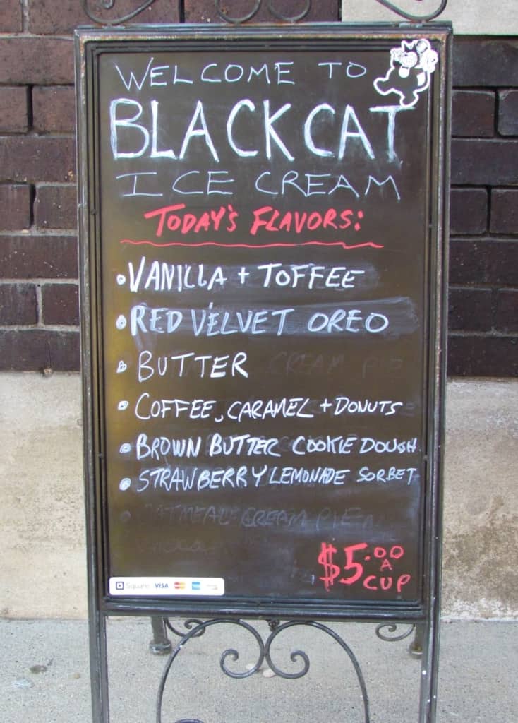 A billboard outside of the shop shows the available flavors for the day.