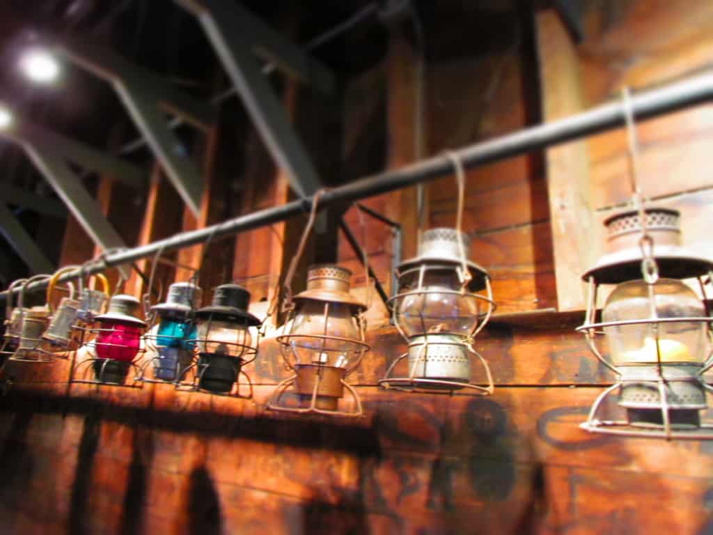 An assortment of lanterns make a pleasant presentation hanging all in a row.
