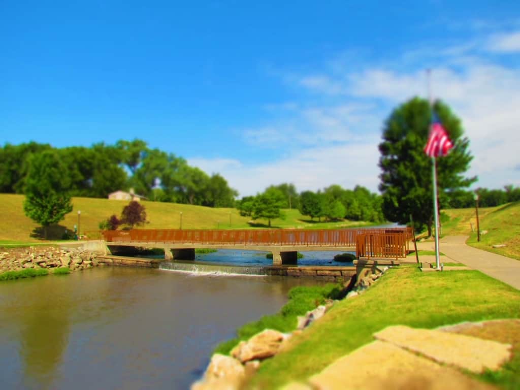 A walking bridge makes crossing the Neosho River easier than it was for wagon trains in the 1800's.