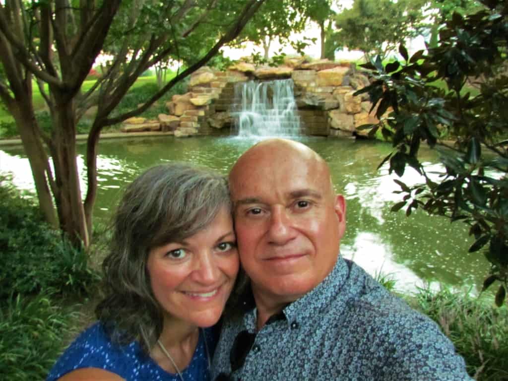 The authors pose for a selfies across from a waterfall.
