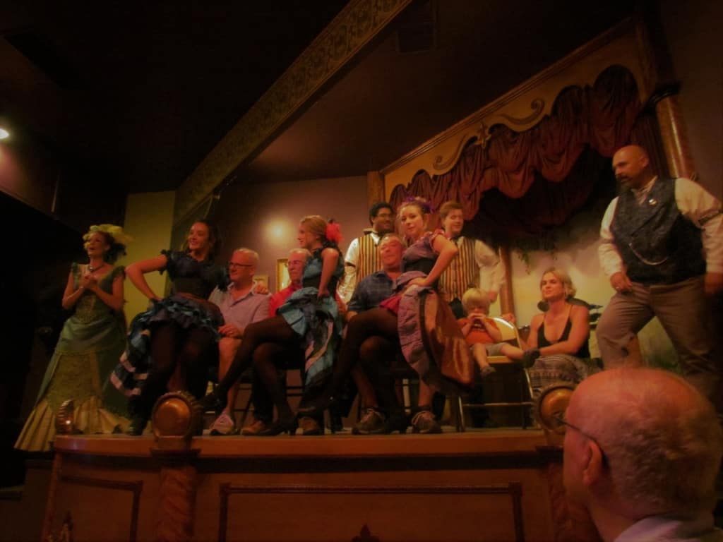 Members of the audience are roped into coming up on stage during a musical act at the Longbranch Saloon.
