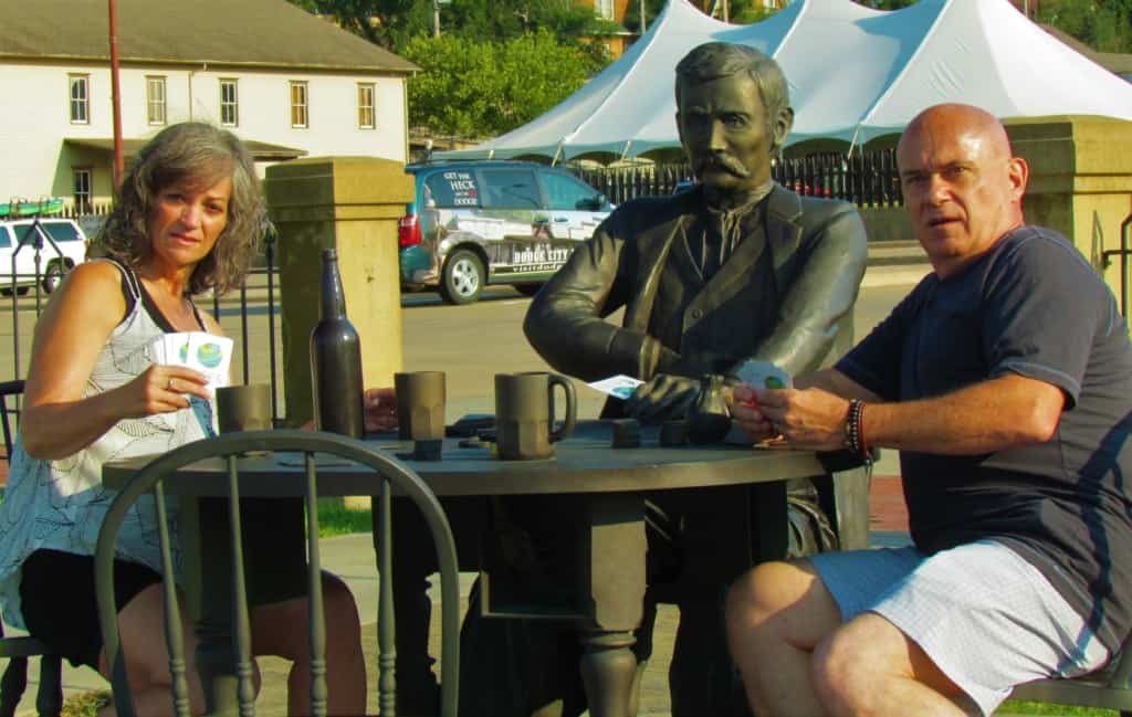 The authors pose with a statue of Doc Holiday at the Boot Hill Museum in Dodge City, Kansas. 