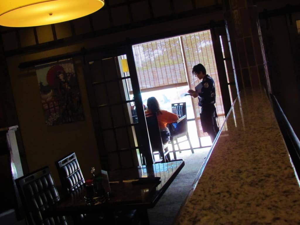 A server takes the order from customers at Oishi Japanese Cuisine. 
