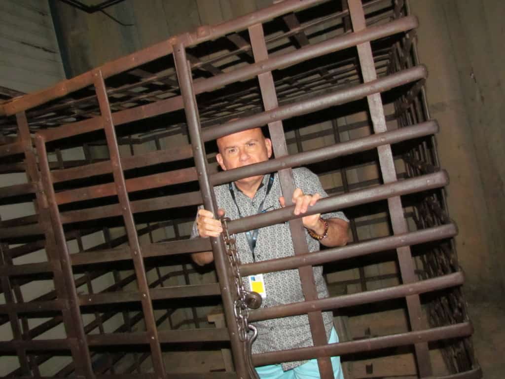 The author poses inside of a jail cell used in the displays.