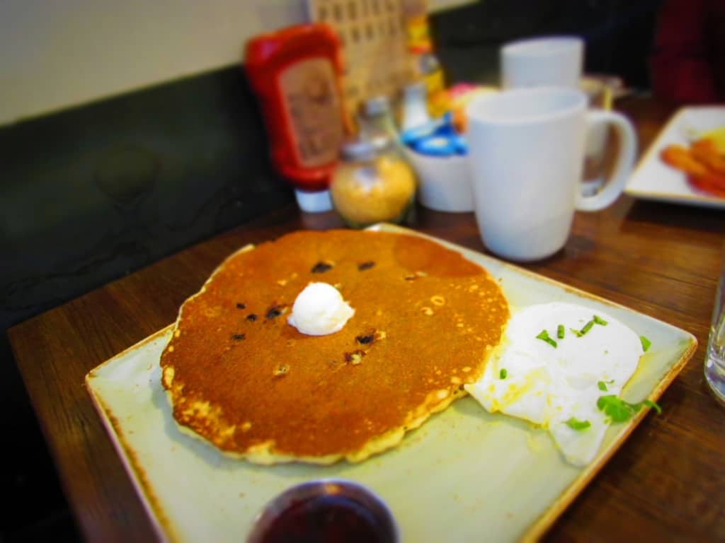Blueberry Pancakes are served with a dressing of blueberry compote.
