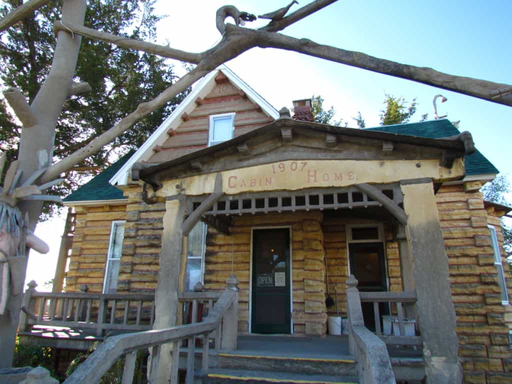 The limestone "log" cabin that Dinsmoor constructed to show tourists to Lucas, kansas. 