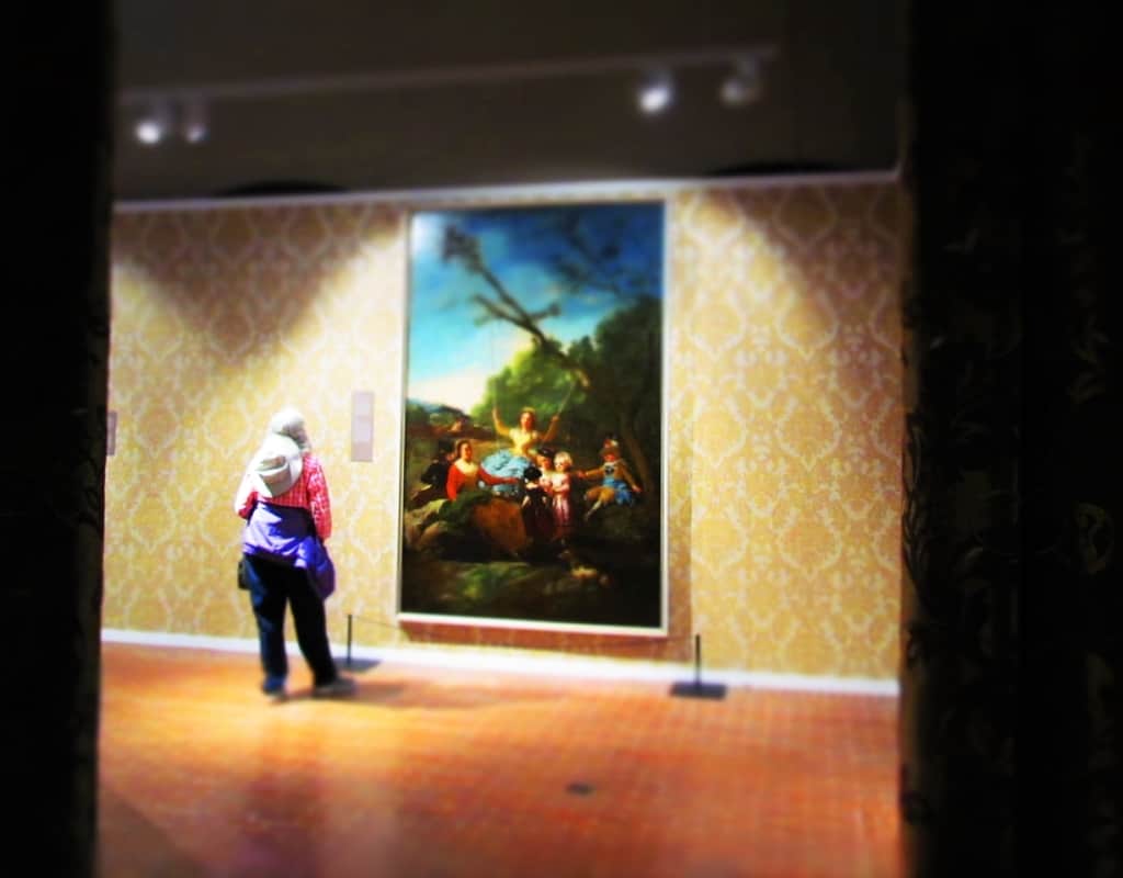 A visitor to the Cabildo examines a painting. 