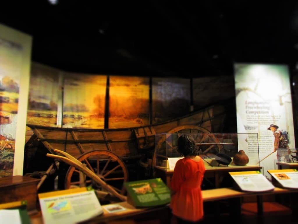 The author examines the information displayed about an exhibit on early pioneers.