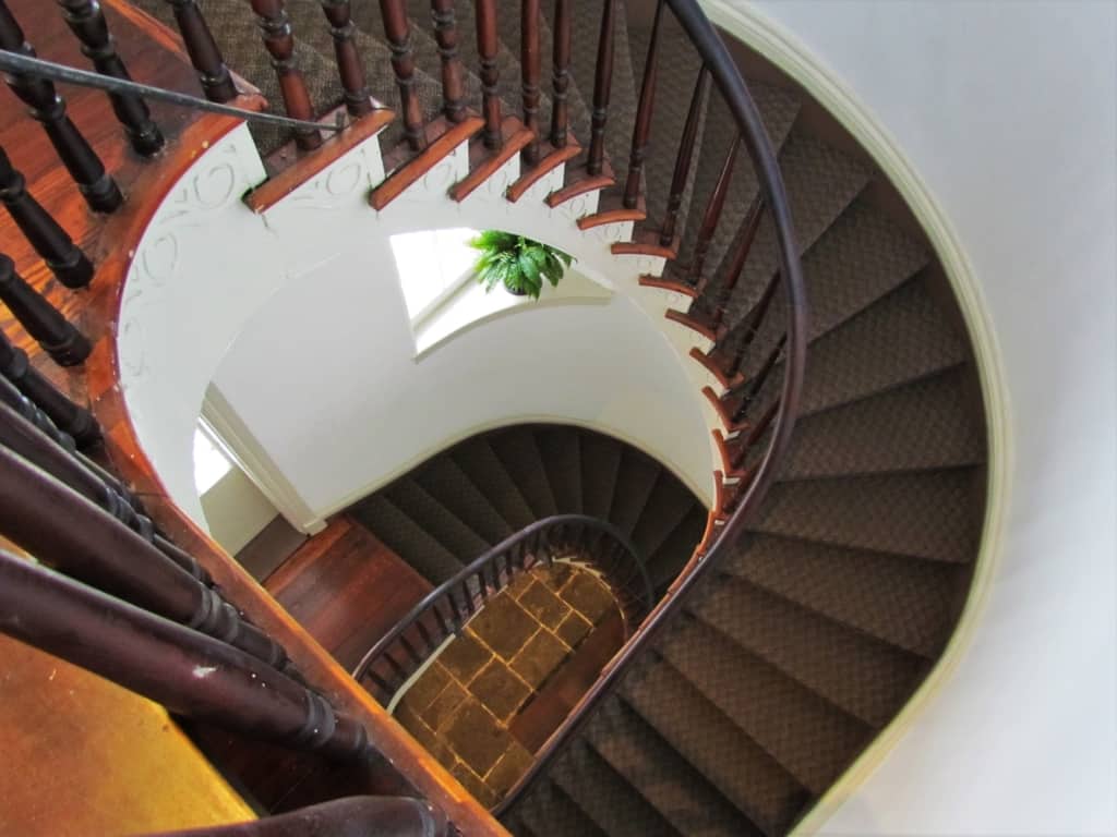 A beautifully designed circular staircase serves an important purpose without taking up too much floor space. 