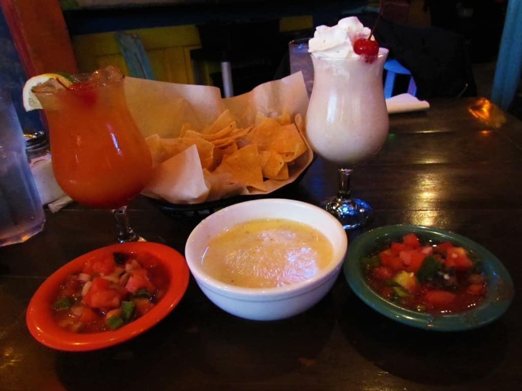 Some Queso dip and salsa with tortilla chips pairs well with a couple of house specialty drinks. 