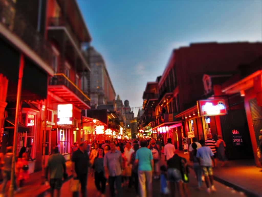 As night falls in New Orleans, the crowds begin to gather on Bourbon Street in the French Quarter.