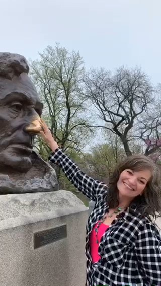 Crystal rubs the nose on the Lincoln bust for good luck. 