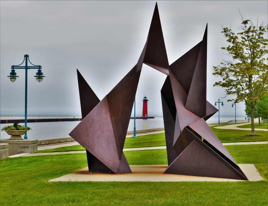 The Kenosha Lighthouse is framed by a piece of art in a nearby park.