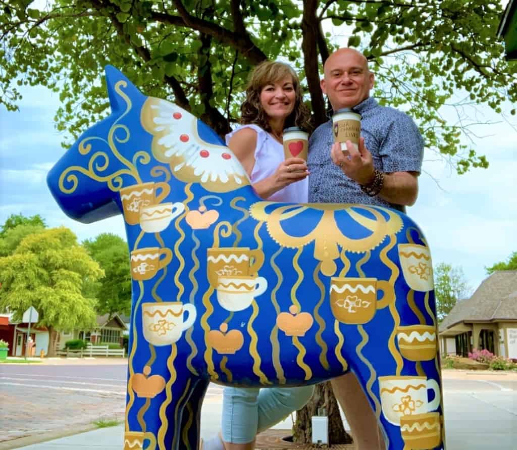 The authors pose for a selfie in front of one of the wild Dala horse herd creations. 