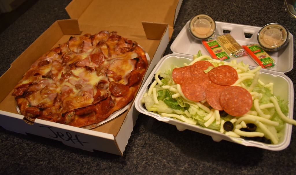 A St. Louis style pizza combines well with a simple salad to make a complete meal. 