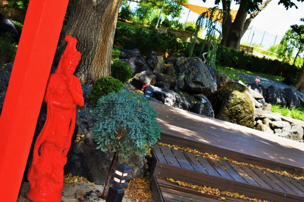 The bright red statues add contrast to the various shades of green found at the Amarillo Botanical Gardens. 