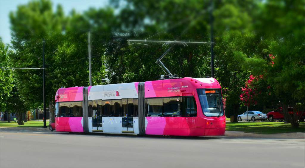 The brightly colored OKC Streetcar is easy to spot as you wait for a ride.