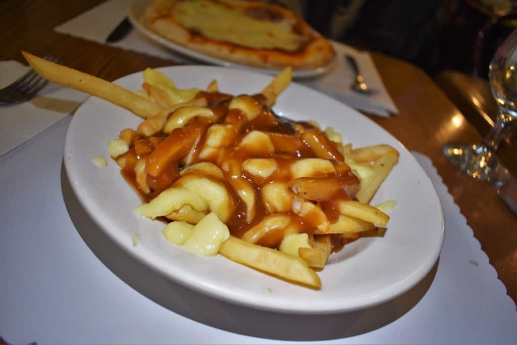 Poutine and pizza make for a carbolicious meal that can be found in Quebec City.