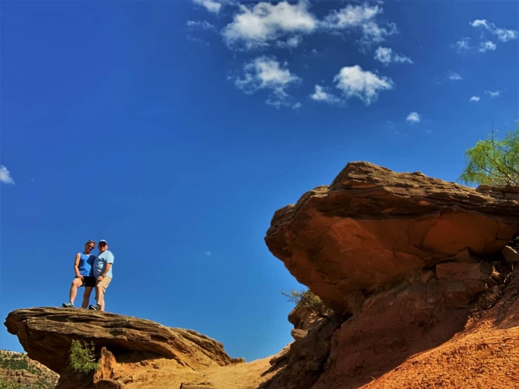 The authors pose on a rocky outcropping on the floor of Palo Duro Canyon.