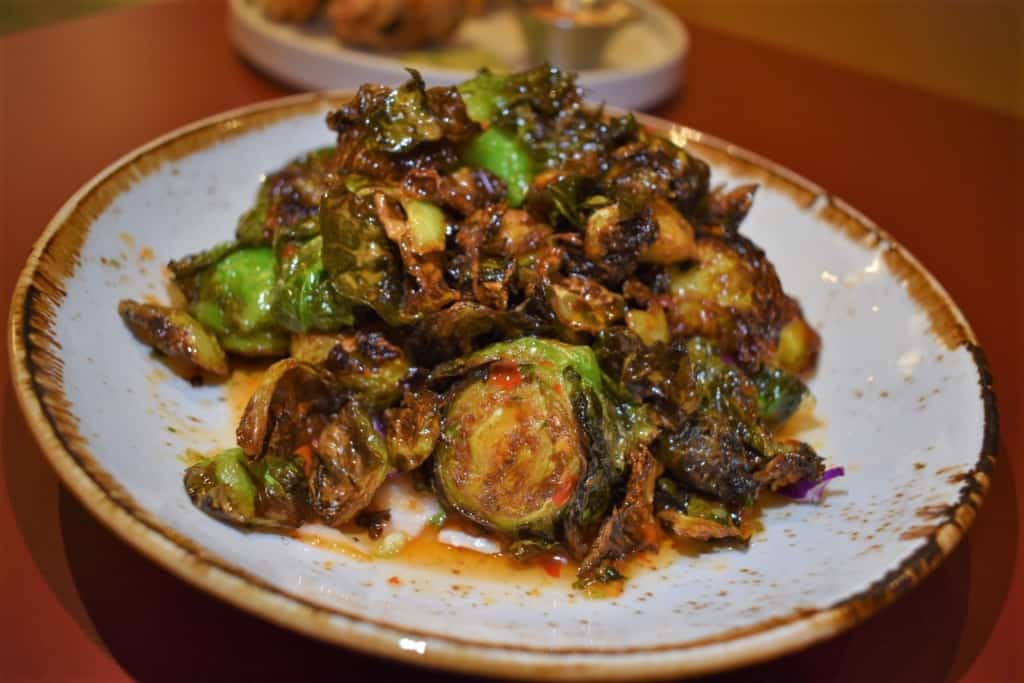 A plate of fried Brussels Sprouts is hard to pass up when coated in a sweet chili sauce.